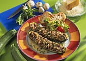 Courgettes with cheese & mushroom stuffing on plate; bread