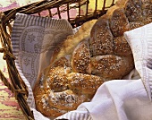 Bread plait with poppy seeds & sesame on cloth in basket