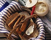 Rhineland black bread in bread basket; butter pot