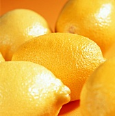 Several lemons on yellow background