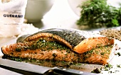 Marinated salmon with dill on chopping board