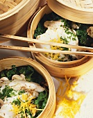 Pike-perch in lemon steam with spinach in bamboo steamer