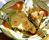 Vegetable lasagne with spinach, mushrooms on coloured plate