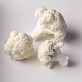 Three cauliflower florets on light background