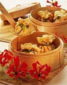 Shrimp parcels in bamboo steamer and on slotted spoon