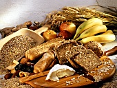 Still life with cereal, wholemeal bread, fruit, cheese