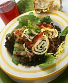 Mixed salad leaves with bacon and pancake roulade