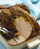 Chicken with herb crust, a slice carved in roasting tin