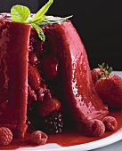 Summer pudding with red berries and mint leaf