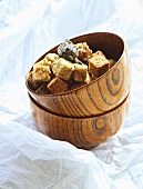 Japanese rice cracker squares in wooden bowl