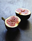 Two fig halves on a slate grey background