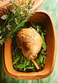 Whole leg of lamb in Römertopf with green beans and herbs