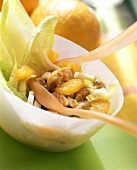 Chicken salad with chicory and oranges in bowl