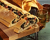 Turkish spinach bread with sheep's cheese on wooden platter