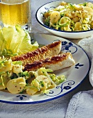 Wollwurst (sausage) with potato and endive salad; beer