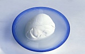 A ball of mozzarella in a blue bowl