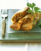 Spring rolls with shrimps; sprig of parsley
