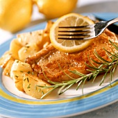Veal cutlets with herbed potatoes and lemon slice