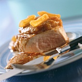 Pork fillet with fruit puree, cut into on plate 
