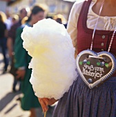 Woman with candy floss and gingerbread heart