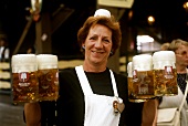 Waitress with full tankards of beer at Oktoberfest