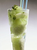 Lime sorbet in glass with lime zest and straws