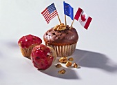 Muffin with chocolate icing & flag; muffin with pink icing