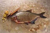 Bream on brown marble with halved potato