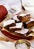 Chocolate cake, cut into rectangles, with icing sugar