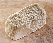 Chene, a French goat's cheese, on brown background