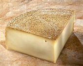 Appenzeller cheese on a reddish background