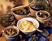 Various pickled gherkins in jars and dishes