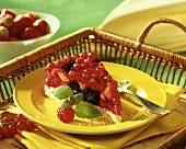 A piece of berry cake on yellow plate on tray