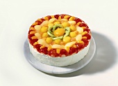 Cream gateau with fruit on marble plate