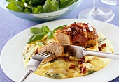 Roast pork on polenta with basil