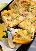 Onion quiche with bacon on a baking sheet