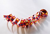 A colourful streamer on a white background