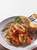 Shrimps with chili, basil and piece of baguette