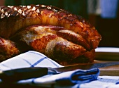 Roast pork with crackling behind tea towel and knife