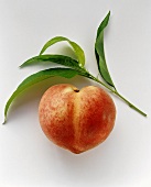 Heart-shaped peach with leaves