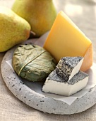 Various types of cheese (raclette, goat's, Banon) with pears