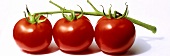 Three vine tomatoes on a white background