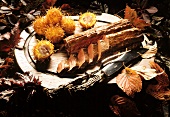 Saddle of venison with chestnuts in pastry case; autumn leaves