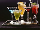 Five different cocktails on a tray
