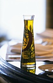 Olive oil with chili pepper and rosemary in a carafe
