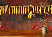 Portuguese smoked sausages hanging on wooden pole