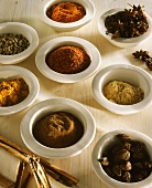 Various spices in white bowls