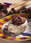 Meringue nests with chocolate cream & chocolate curls on plate