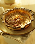 Apple and pear tart with icing sugar on plate