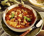 Tomato and bean soup with noodles, mussels and basil